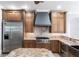 Well-equipped kitchen with stainless steel appliances, custom cabinetry, granite countertops, and a stylish range hood at 7440 Riverside Dr, Punta Gorda, FL 33982