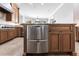 A kitchen island features stainless steel dishwasher drawers and complements granite countertops and tile flooring at 7440 Riverside Dr, Punta Gorda, FL 33982