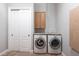 Functional laundry room with white front load machines and granite countertops at 7440 Riverside Dr, Punta Gorda, FL 33982