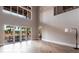 Expansive living room with tile floors, high ceilings, and floor-to-ceiling windows showcasing the backyard patio at 7440 Riverside Dr, Punta Gorda, FL 33982