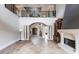 Grand living space featuring an elegant staircase, stone columns, fireplace and archways to other rooms at 7440 Riverside Dr, Punta Gorda, FL 33982