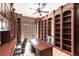Spacious office features custom wood bookshelves, ceiling fan, desk and exterior access to outdoor space at 7440 Riverside Dr, Punta Gorda, FL 33982