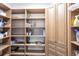 A spacious pantry features ample shelving and custom cabinetry for organized storage at 7440 Riverside Dr, Punta Gorda, FL 33982