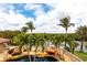 Aerial view of the pool area, with tropical landscaping and a relaxing waterfront view at 7440 Riverside Dr, Punta Gorda, FL 33982