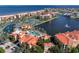 Stunning aerial view of a waterfront community with tennis courts and pools at 85 Vivante Blvd # 8542, Punta Gorda, FL 33950