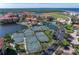 Aerial view of tennis courts and a lush community overlooking the ocean at 85 Vivante Blvd # 8542, Punta Gorda, FL 33950