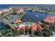Aerial view showcasing a waterfront community, tennis courts, community pool, and lush landscaping at 85 Vivante Blvd # 8542, Punta Gorda, FL 33950