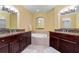 Large bathroom with granite countertops, tiled flooring, large bathtub, and updated vanity at 85 Vivante Blvd # 8542, Punta Gorda, FL 33950