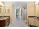 Large bathroom with granite countertops, tiled flooring, glass shower, and updated vanity at 85 Vivante Blvd # 8542, Punta Gorda, FL 33950
