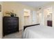 Bedroom with a large dresser and openings to a walk-in closet and en-suite bathroom at 85 Vivante Blvd # 8542, Punta Gorda, FL 33950