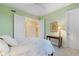 Bedroom with a bed, a desk, closet doors, and a bathroom entrance at 85 Vivante Blvd # 8542, Punta Gorda, FL 33950