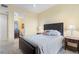 A well-lit bedroom featuring neutral colors and a partial view into an en-suite bathroom at 85 Vivante Blvd # 8542, Punta Gorda, FL 33950
