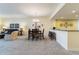 Dining area open to the living room and kitchen, featuring a modern chandelier and breakfast bar seating at 85 Vivante Blvd # 8542, Punta Gorda, FL 33950