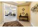 Inviting foyer with tile flooring, decorative rug, stylish console table, and an open view into the living area at 85 Vivante Blvd # 8542, Punta Gorda, FL 33950