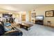 Spacious living room with carpet, couch, TV, and an open layout to the dining area and kitchen at 85 Vivante Blvd # 8542, Punta Gorda, FL 33950
