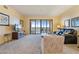Bright living room features neutral walls, plush carpeting, comfortable seating, and access to a screened balcony at 85 Vivante Blvd # 8542, Punta Gorda, FL 33950