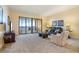 Bright living room with a sliding glass door to a balcony showcasing water views, and comfortable furniture at 85 Vivante Blvd # 8542, Punta Gorda, FL 33950