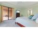 Bedroom featuring neutral walls, carpet flooring, ceiling fan, and sliding glass door to a patio at 85 Vivante Blvd # 8542, Punta Gorda, FL 33950