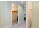 Bedroom hallway featuring a door to a walk-in closet with shelving and carpet flooring at 85 Vivante Blvd # 8542, Punta Gorda, FL 33950