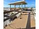 A beach pavilion sits on a sandy shore, with a wooden walkway leading to it and the ocean in the background at 9400 Little Gasparilla Is # C2, Placida, FL 33946