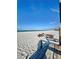 Picturesque beach scene showing white sand and clear ocean waters under a bright, cloud-streaked blue sky at 9400 Little Gasparilla Is # C2, Placida, FL 33946