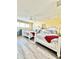 Bright bedroom features two white beds with gray bedding, red throws, and a ceiling fan at 9400 Little Gasparilla Is # C2, Placida, FL 33946
