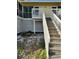Exterior of a two-story home with wooden stairs leading to the entrance at 9400 Little Gasparilla Is # C2, Placida, FL 33946