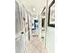 Bright hallway with tile floors leads to various rooms, including a bathroom and kitchen area at 9400 Little Gasparilla Is # C2, Placida, FL 33946
