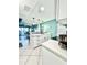 Bright kitchen featuring white cabinets, stainless steel appliances, and a modern island with a sink at 9400 Little Gasparilla Is # C2, Placida, FL 33946