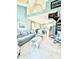 Comfortable living space with spiral staircase, eat-in kitchen, modern fan, and tiled floors at 9400 Little Gasparilla Is # C2, Placida, FL 33946