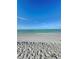 Serene ocean view displaying calm waters meeting a sandy beach under a clear sky, ideal for relaxation at 9400 Little Gasparilla Is # C2, Placida, FL 33946