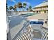 Community pool and lounge area with chairs and umbrellas at 9400 Little Gasparilla Is # C2, Placida, FL 33946