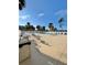 Community swimming pool area with lounge chairs and palm trees at 9400 Little Gasparilla Is # C2, Placida, FL 33946