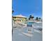 Outdoor pool and lounge area with chairs, umbrellas, and a clear sky at 9400 Little Gasparilla Is # C2, Placida, FL 33946