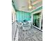 Cozy porch area with wicker chairs, patterned rug, and sliding glass door at 9400 Little Gasparilla Is # C2, Placida, FL 33946