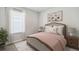 Serene bedroom featuring a large bed and floral artwork at 9519 Turtle Grass Cir, Punta Gorda, FL 33950