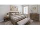 Comfortable bedroom featuring a bed, nightstands, bench, and art prints at 9519 Turtle Grass Cir, Punta Gorda, FL 33950