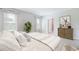 Bright bedroom with neutral tones, large windows, and stylish furnishings enhance a relaxing atmosphere at 9519 Turtle Grass Cir, Punta Gorda, FL 33950