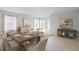 Bright living room with a dining area, sofa, and console table, perfect for entertaining at 9519 Turtle Grass Cir, Punta Gorda, FL 33950