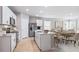 Open-concept kitchen and living space with an island and dining table at 9519 Turtle Grass Cir, Punta Gorda, FL 33950