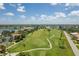 Expansive aerial view showcasing the golf course, serene lake, and well-maintained landscaping of the community at 10488 Princess Ct, Punta Gorda, FL 33955