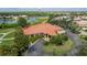 An aerial view showcases a community center with a beautiful landscape and a view of the lake at 10488 Princess Ct, Punta Gorda, FL 33955