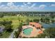 An aerial view shows a community pool, tennis courts, and golf course in a lush landscape at 10488 Princess Ct, Punta Gorda, FL 33955