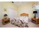 Cozy bedroom with a wicker bed frame, floral bedding, and matching wicker nightstands at 10488 Princess Ct, Punta Gorda, FL 33955