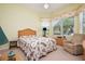 Cozy bedroom with a floral comforter, a wicker bed frame, and a ceiling fan at 10488 Princess Ct, Punta Gorda, FL 33955