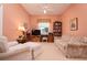 Cozy bedroom with plush carpeting, a ceiling fan, a large window, and comfortable seating for relaxation at 10488 Princess Ct, Punta Gorda, FL 33955