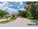 Guarded gate entrance into Seminole Lakes Community framed by lush landscaping and blue skies at 10488 Princess Ct, Punta Gorda, FL 33955