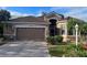 Charming single-story home with lush landscaping and a two-car garage with a stone paver driveway at 10488 Princess Ct, Punta Gorda, FL 33955
