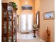 Inviting foyer with high ceilings, decorative glass doors, and a display cabinet for showcasing decor at 10488 Princess Ct, Punta Gorda, FL 33955