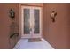 Elegant double front doors with decorative glass panels and neutral accents at 10488 Princess Ct, Punta Gorda, FL 33955